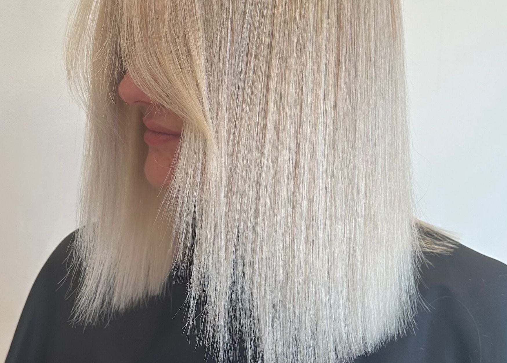 Sleek blonde hair styled at Hair By Eden Carruthers, Melbourne, Victoria, AU.