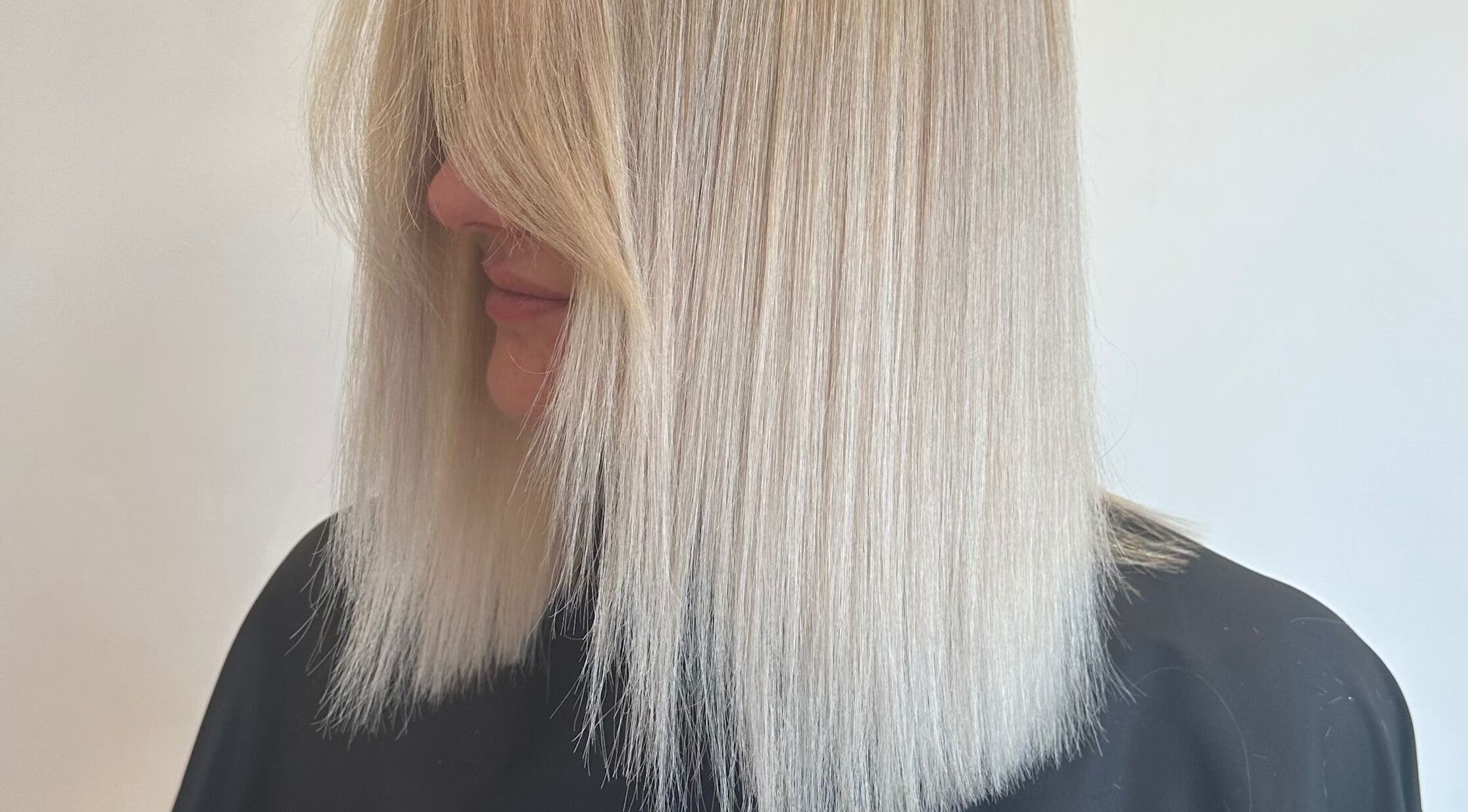 Sleek blonde hair styled at Hair By Eden Carruthers, Melbourne, Victoria, AU.