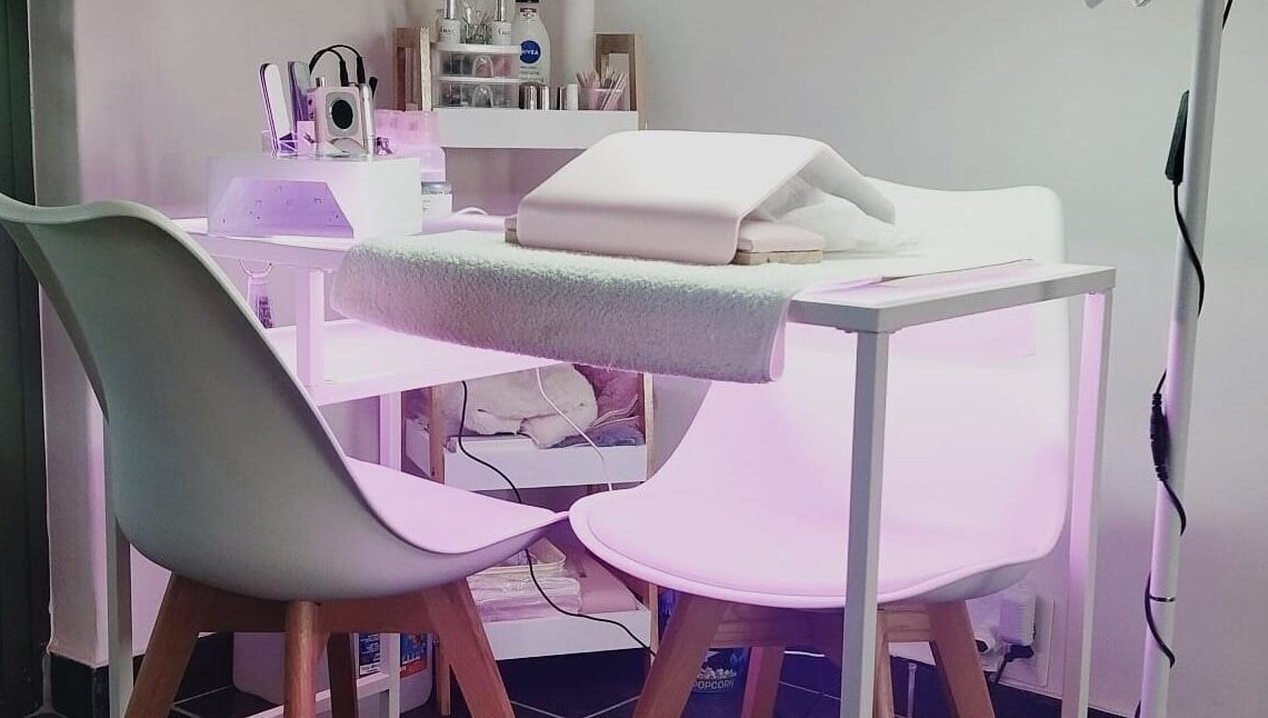 Modern nail station at Nails By Kim in Pretoria, Gauteng, ZA, featuring stylish white chairs and professional equipment.