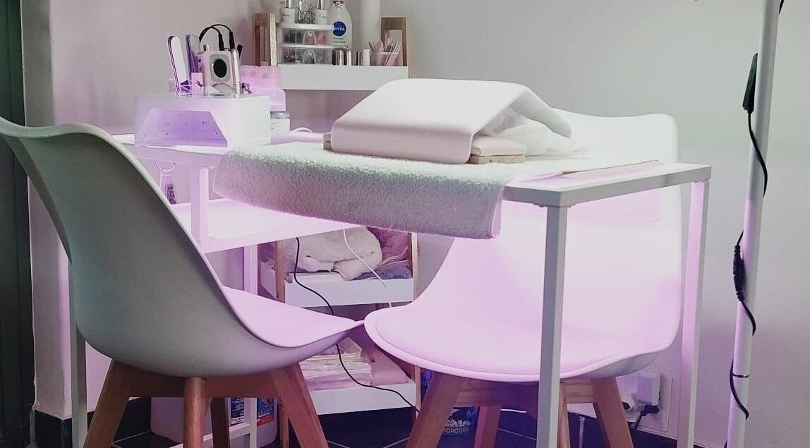 Modern nail station at Nails By Kim in Pretoria, Gauteng, ZA, featuring stylish white chairs and professional equipment.