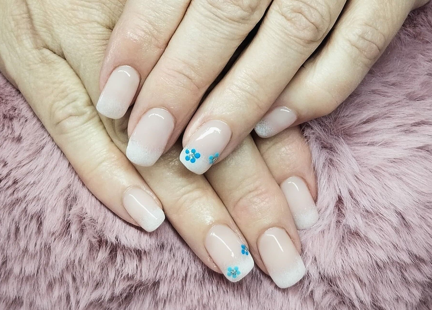 Beautiful French manicure with floral accents by Nails By Kim, Pretoria, Gauteng, ZA.