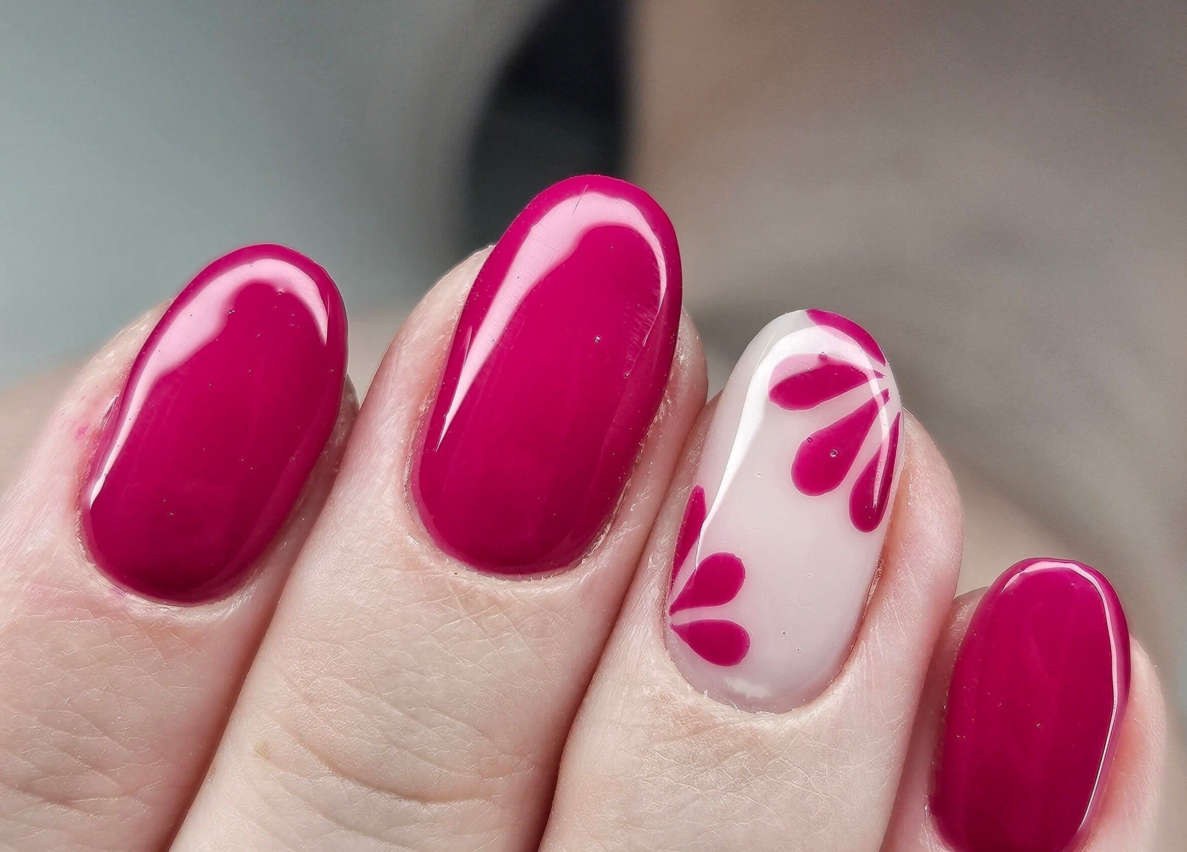Bold magenta nails with accent floral design at cwbeautyofficial in Milnrow, England, GB.
