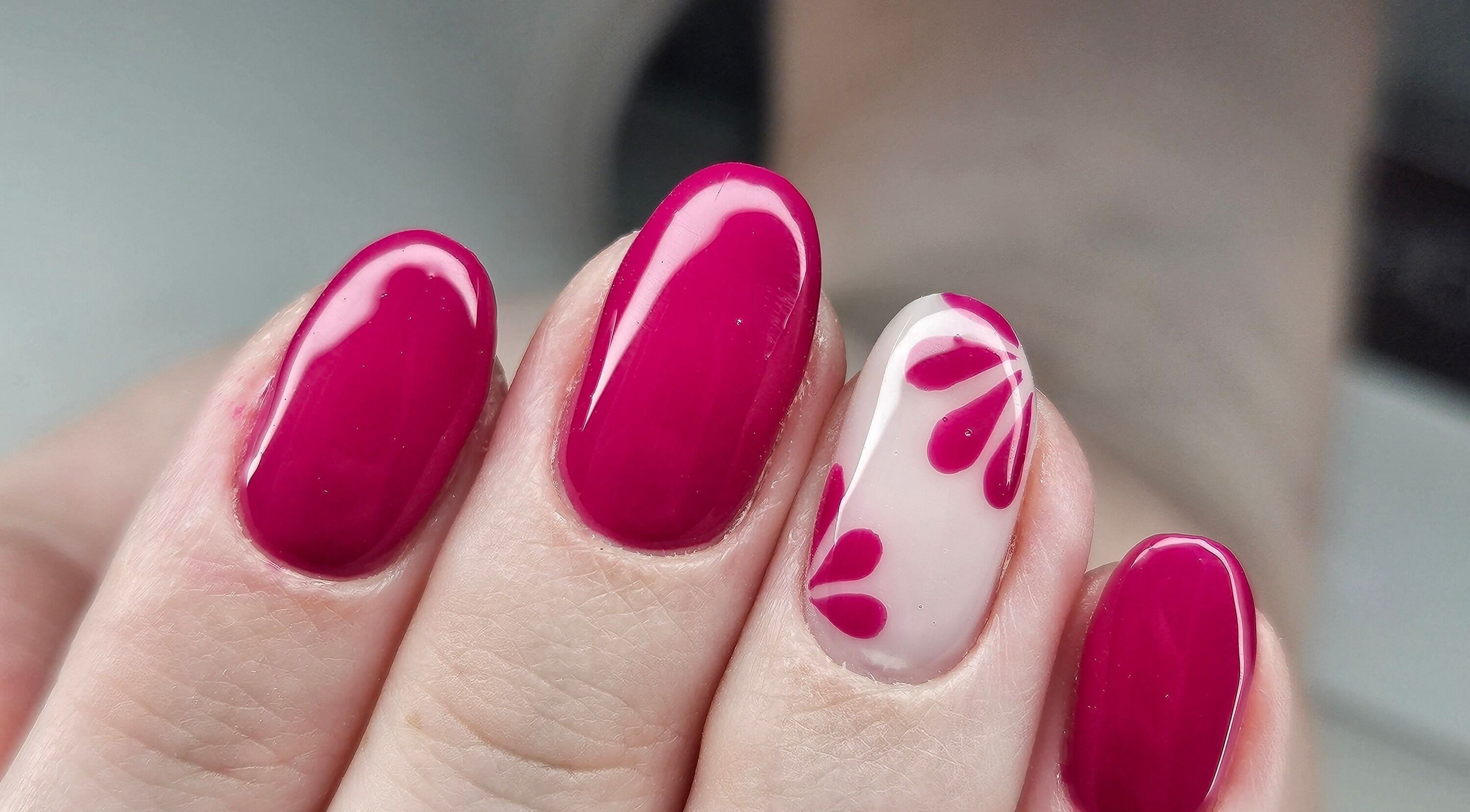Bold magenta nails with accent floral design at cwbeautyofficial in Milnrow, England, GB.