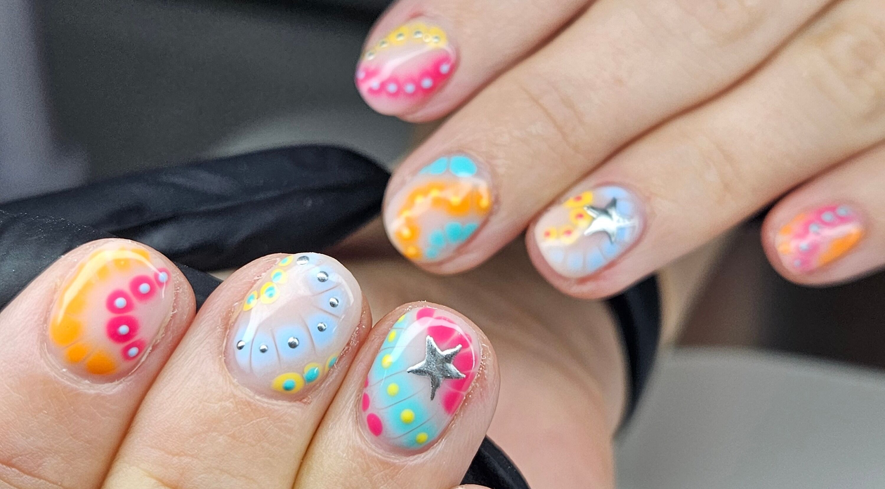 Colorful nail art with star details at cwbeautyofficial, Milnrow, England, GB.