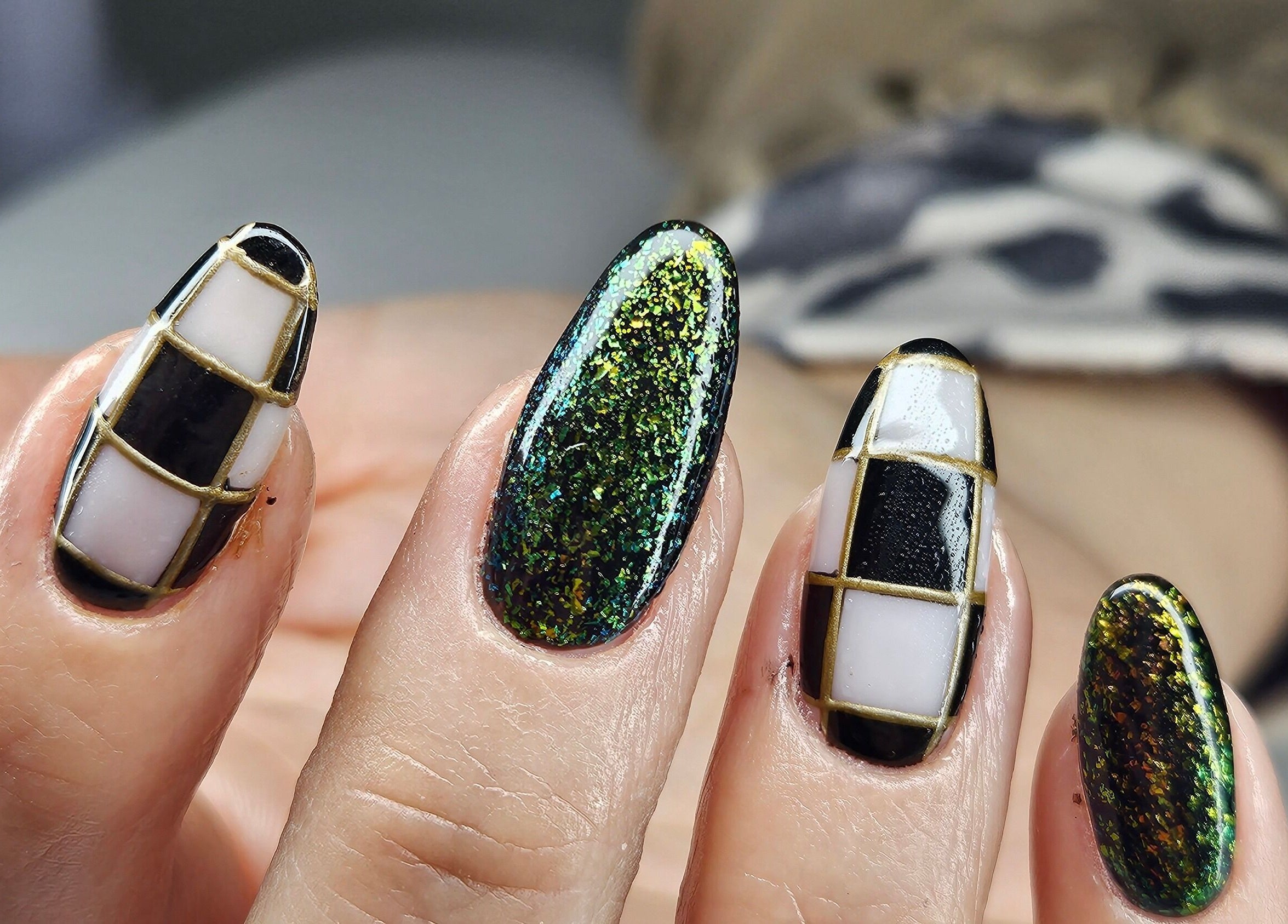 Stylish black and green geometric nails at cwbeautyofficial, Milnrow, England, GB.