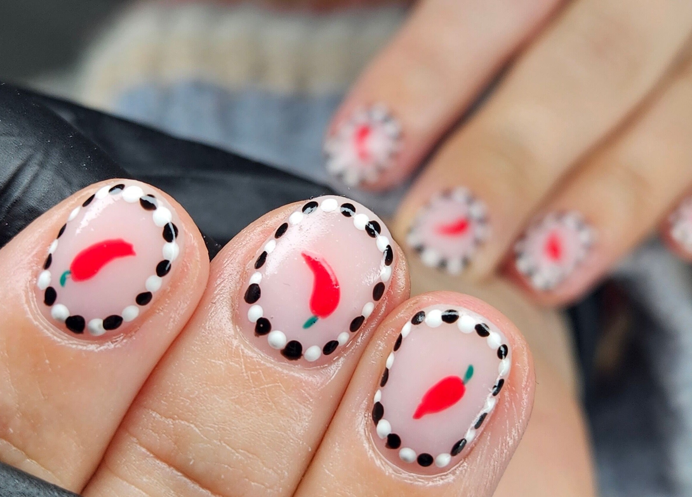 Chili pepper nail art design at cwbeautyofficial, Milnrow, England, GB showcasing detailed craftsmanship.