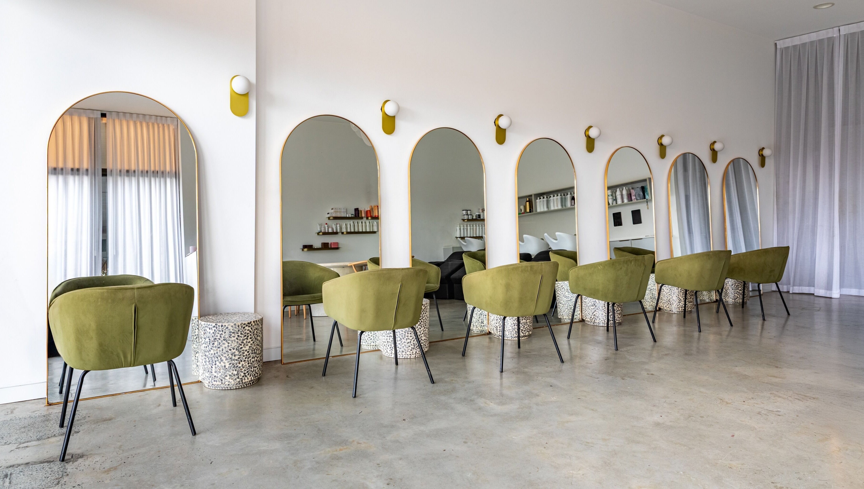 Chic styling chairs and large mirrors at Cali Studio in Campbell, Australian Capital Territory, AU.