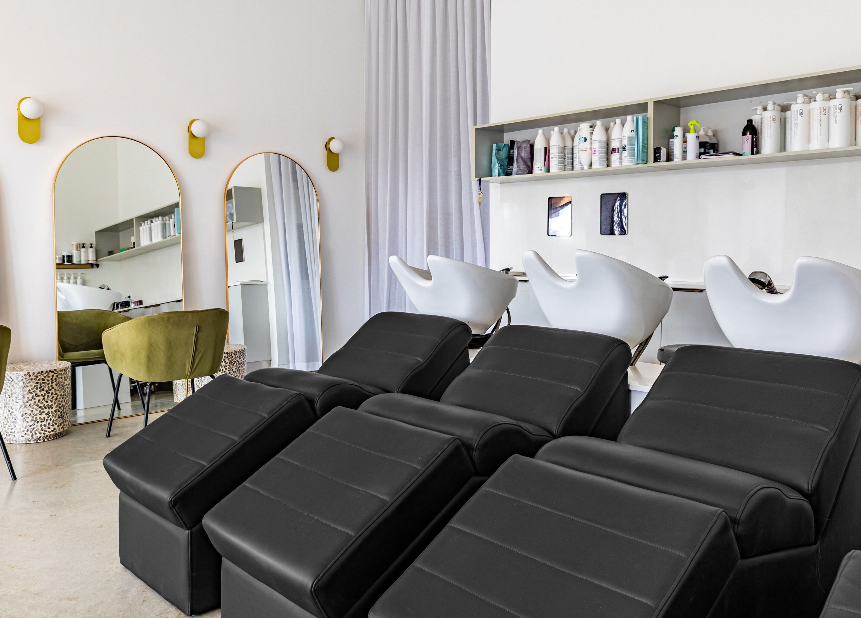 Cali Studio salon interior in Campbell, Australian Capital Territory, AU with modern hair washing stations.