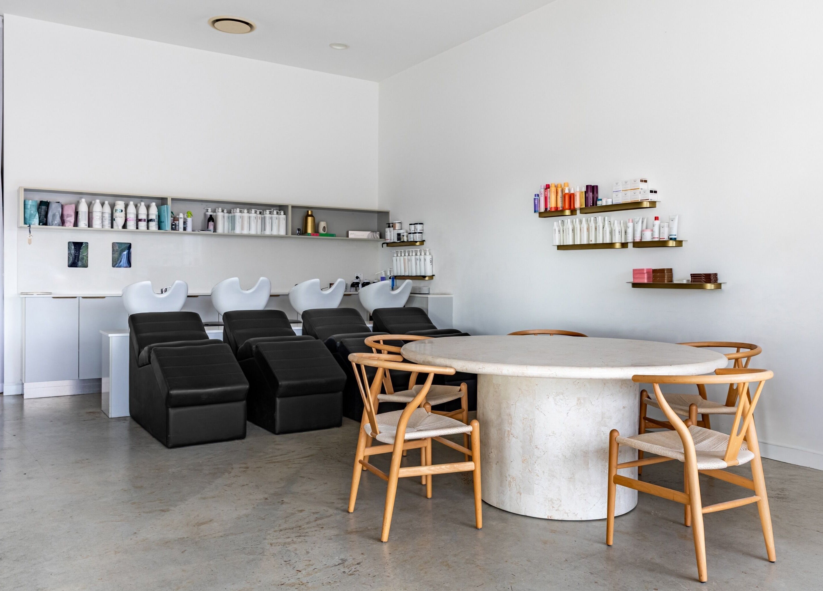 Cali Studio's elegant salon area with chic seating and product displays in Campbell, Australian Capital Territory, AU.