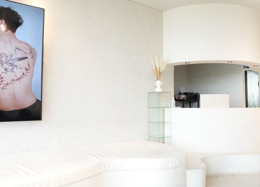 Reception area of Amor Fati Tattoo Studio in Bali, showcasing minimalist design and tattoo art.