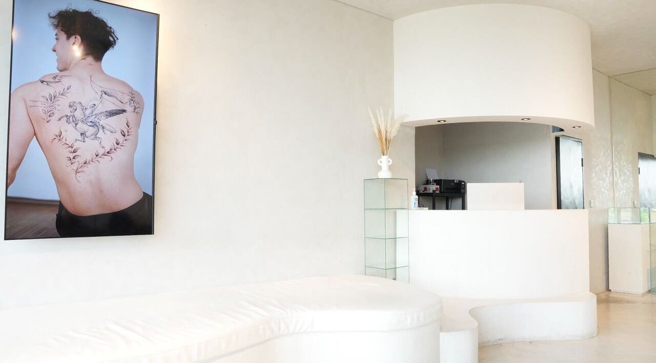 Reception area of Amor Fati Tattoo Studio in Bali, showcasing minimalist design and tattoo art.