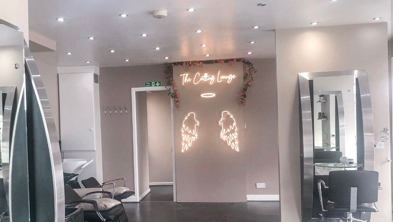 Elegant interior of BabesLengths in Blackpool, England, with stylish decor and modern salon chairs.