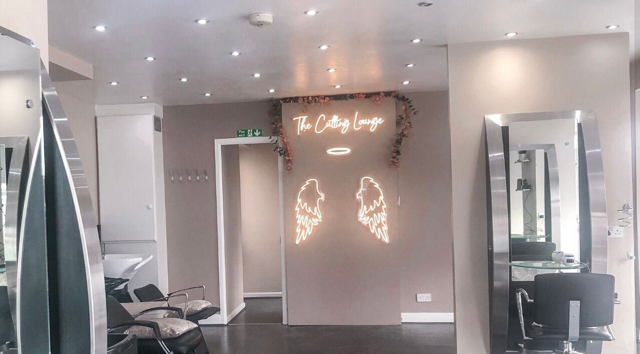 Elegant interior of BabesLengths in Blackpool, England, with stylish decor and modern salon chairs.