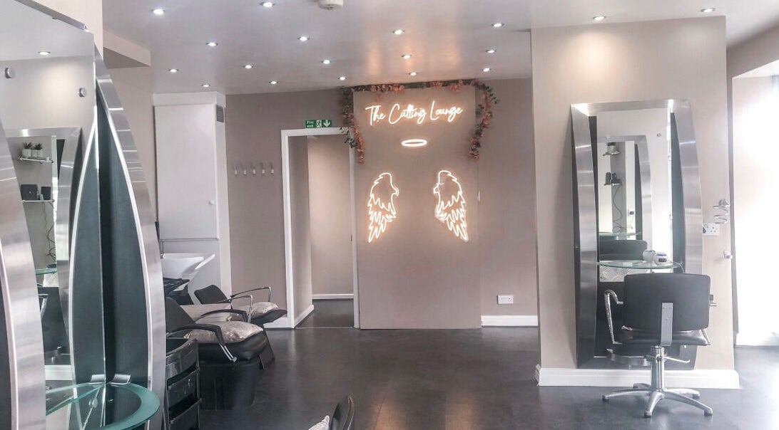 Modern salon interior at BabesLengths, Blackpool, England, GB, with chic mirrors and elegant decor.