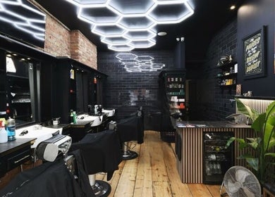Modern barber shop interior at The Cut LDN, London, England, GB, featuring sleek design and unique lighting.