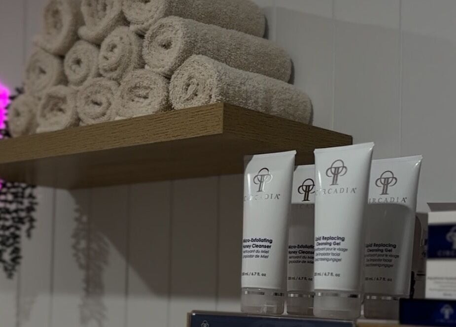 Shelf with rolled towels and skincare at Skin and Brow Bar By Gabrielle, Portsmith, Queensland, AU.