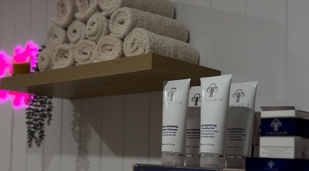 Shelf with rolled towels and skincare at Skin and Brow Bar By Gabrielle, Portsmith, Queensland, AU.