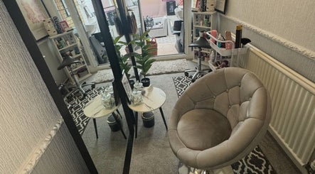 Relaxing seating area at ChloeMossHair&Beauty in Sudbrooke, England, GB, featuring elegant decor and styling setup.