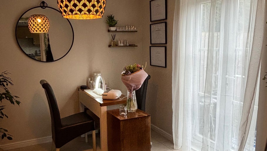 Cozy treatment room at Solely Elegant, Thornaby, England, GB with a chic mirror and soft lighting.