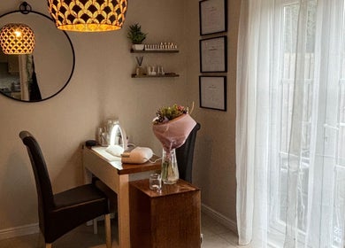 Cozy treatment room at Solely Elegant, Thornaby, England, GB with a chic mirror and soft lighting.