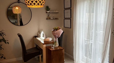 Cozy treatment room at Solely Elegant, Thornaby, England, GB with a chic mirror and soft lighting.