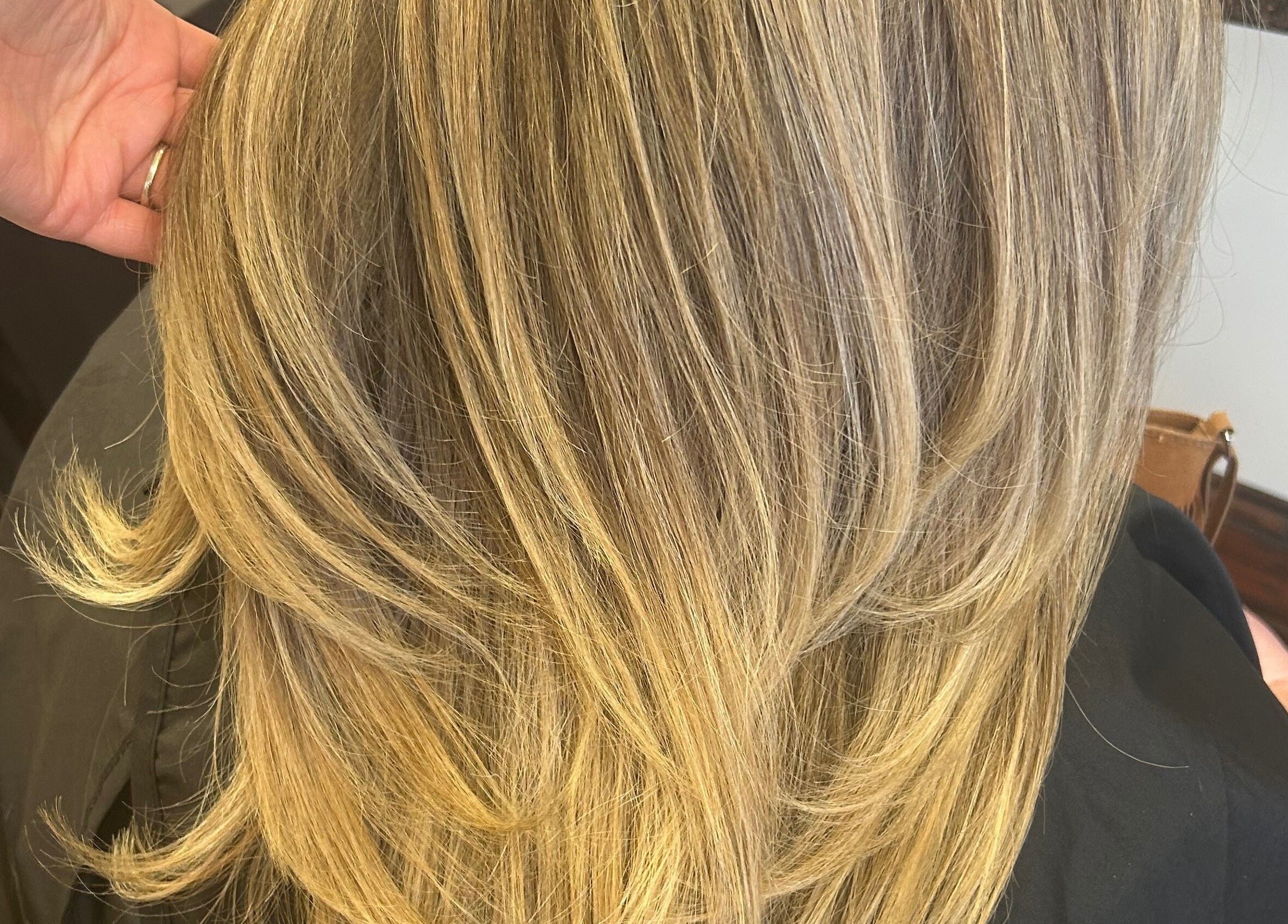Blonde layered hairstyle at Sian’s Hairdressing in Nuneaton, England, GB showcasing smooth, sleek hair.