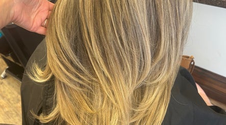 Blonde layered hairstyle at Sian’s Hairdressing in Nuneaton, England, GB showcasing smooth, sleek hair.