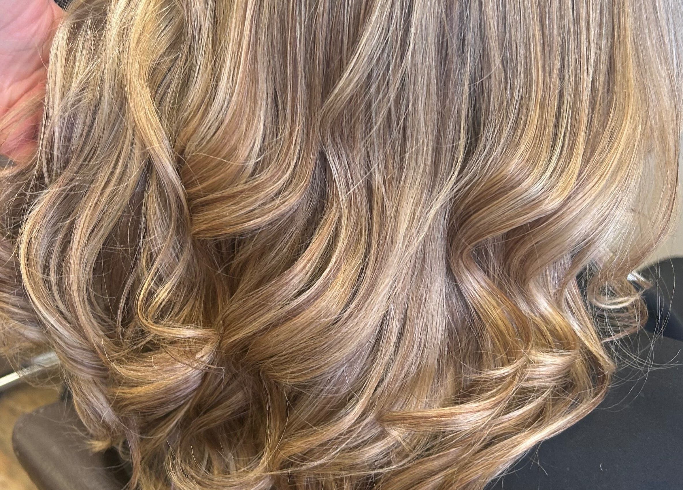 Golden wavy hairstyle at Sian’s Hairdressing in Nuneaton, England, GB. Perfect for modern hair transformation.