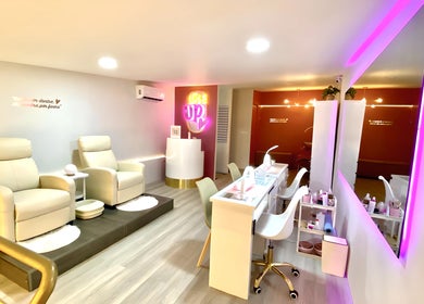 Interior elegante de `Love Up` en Villahermosa, Tabasco, MX, mostrando cómodas sillas y mesas de belleza.