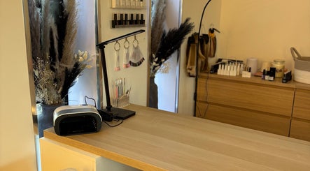 Nail station setup at Macie Jones Studios in Aberdare, Wales, GB with polish display and tools.