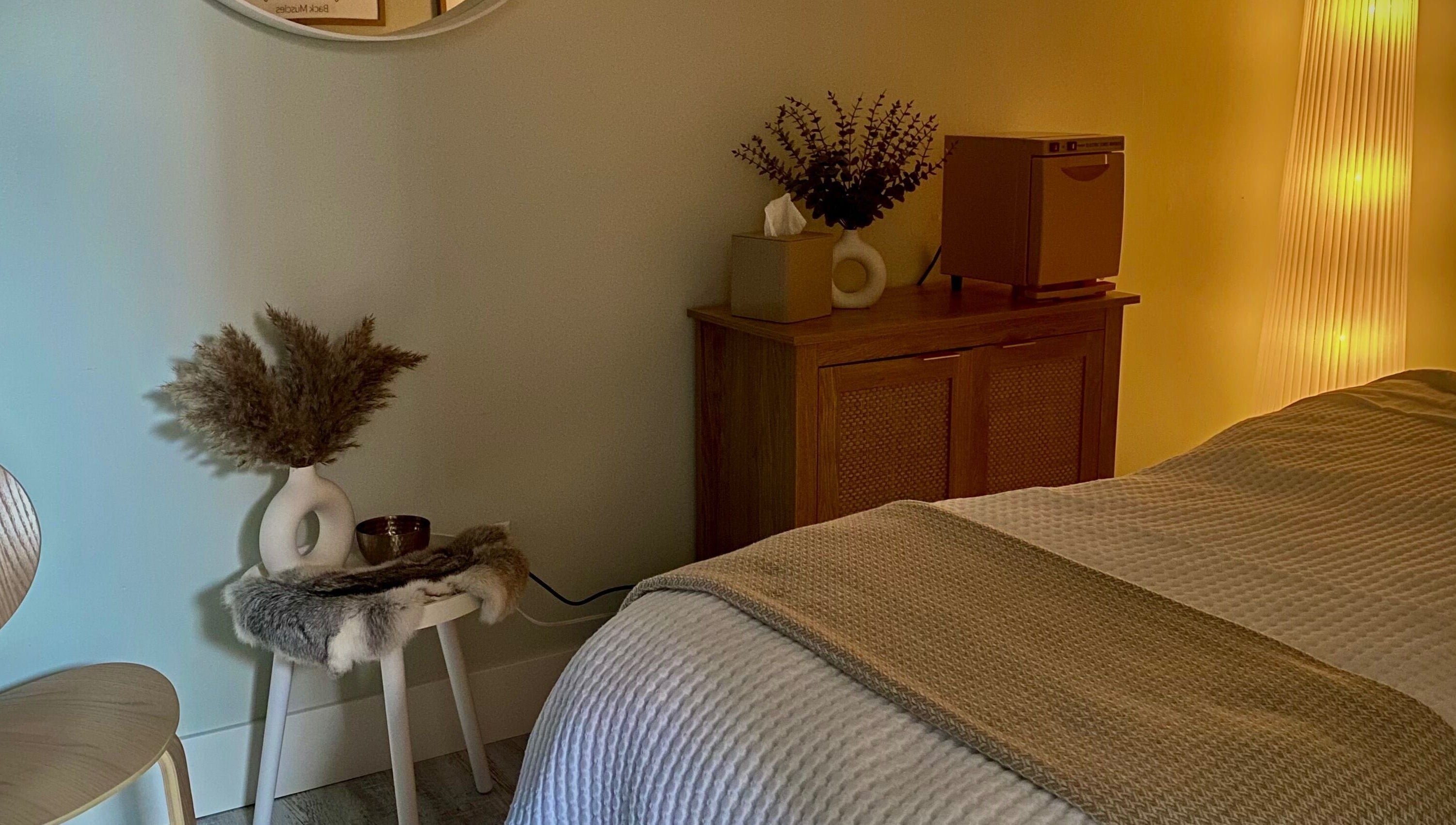 Relaxing spa room at Inua Spa, Yarmouth, Nova Scotia, CA with warm lighting and calming decor.