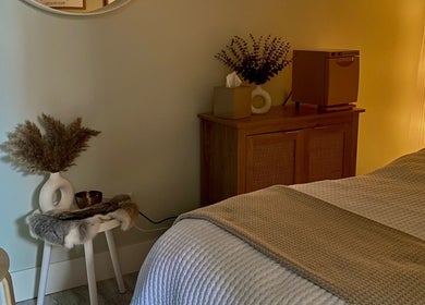 Relaxing spa room at Inua Spa, Yarmouth, Nova Scotia, CA with warm lighting and calming decor.