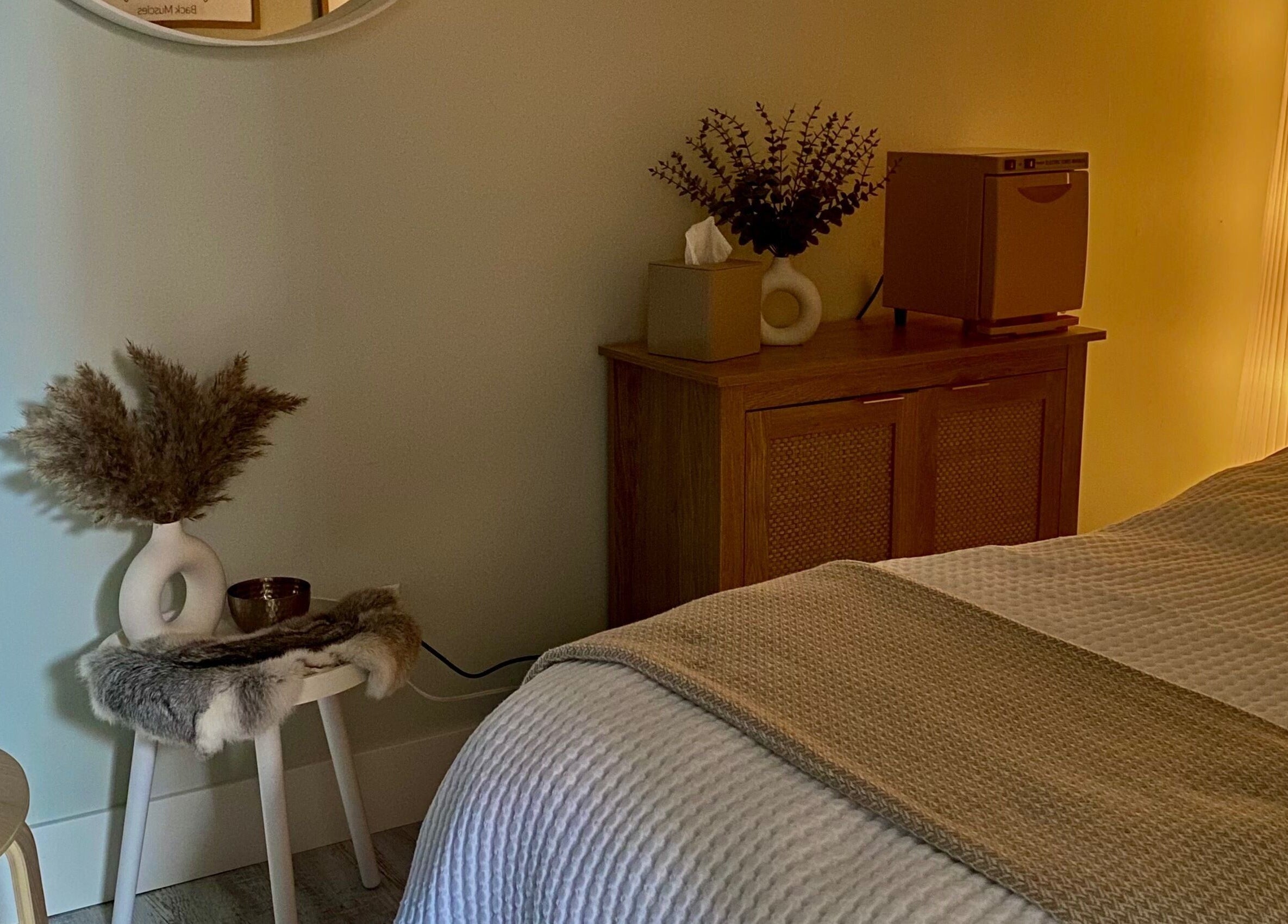 Relaxing spa room at Inua Spa, Yarmouth, Nova Scotia, CA with warm lighting and calming decor.