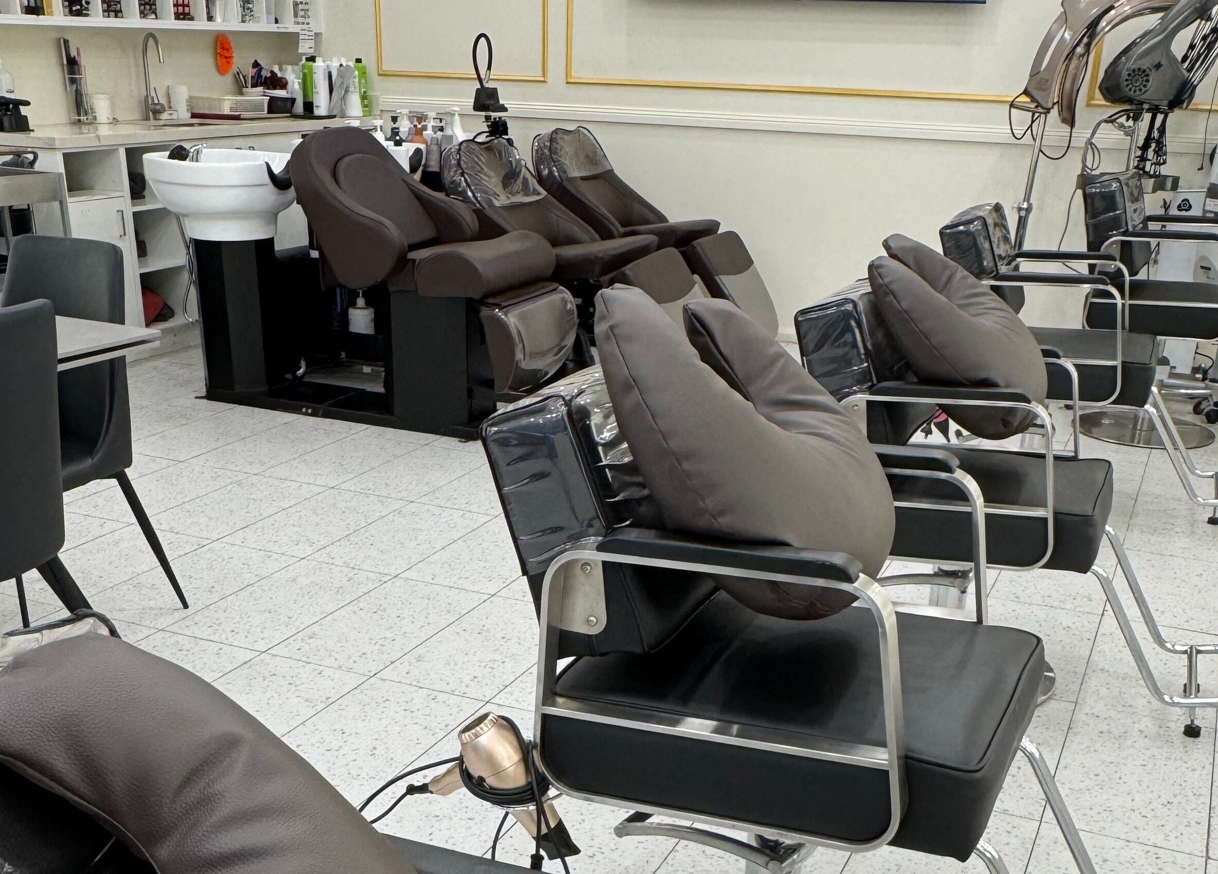 Modern salon chairs at L’atelier no.1, Sydney, New South Wales, AU, showcasing a sleek and inviting setup.
