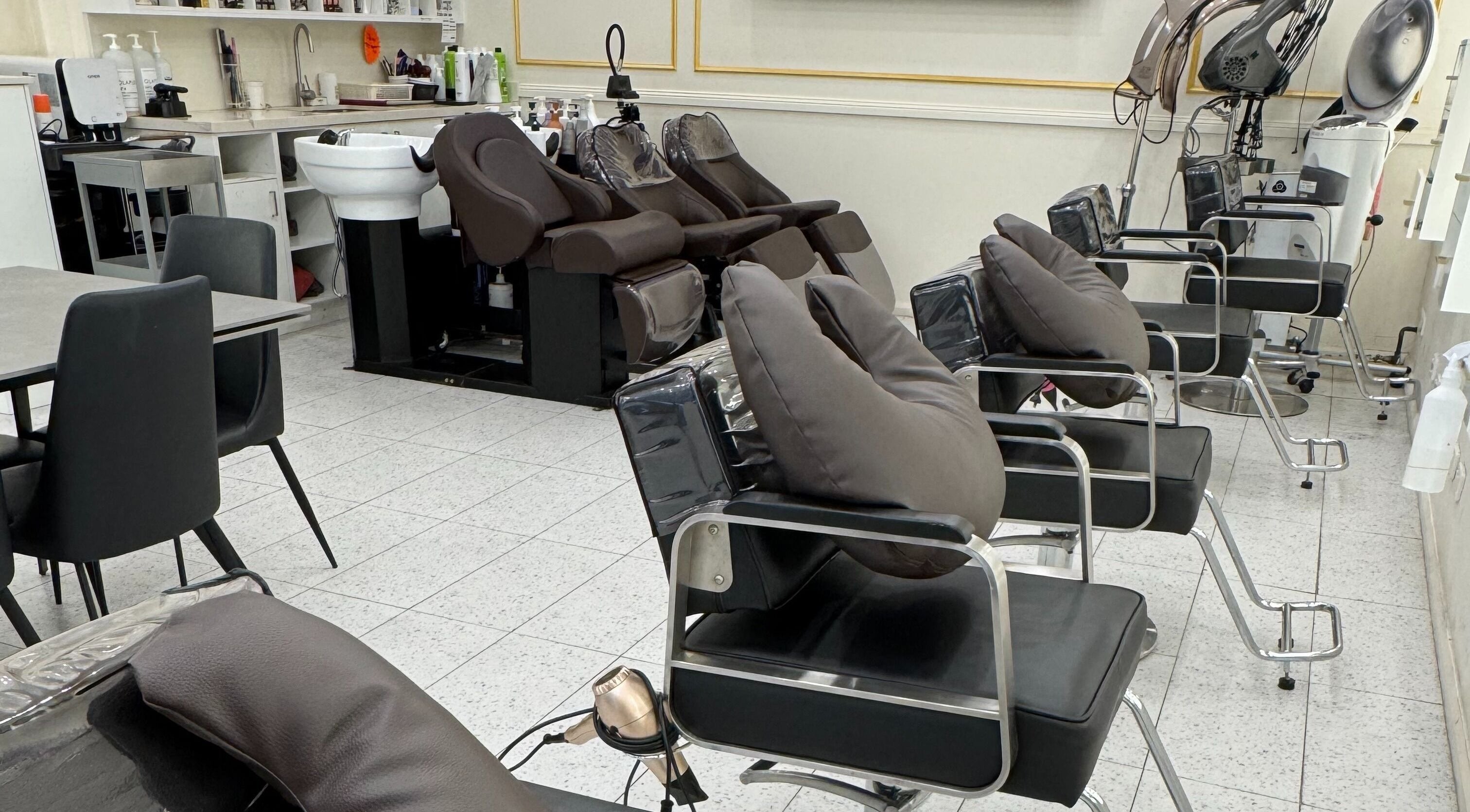 Modern salon chairs at L’atelier no.1, Sydney, New South Wales, AU, showcasing a sleek and inviting setup.