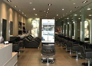 Modern interior of She hairdressing in Melbourne, Victoria, AU with sleek salon chairs and mirrors.