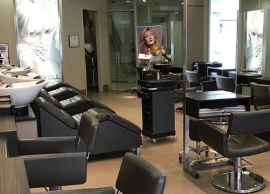 Modern interior of She Hairdressing in Melbourne, Victoria, AU with stylish chairs and wash stations.