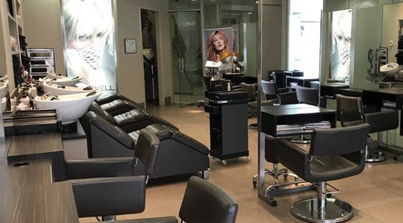 Modern interior of She Hairdressing in Melbourne, Victoria, AU with stylish chairs and wash stations.