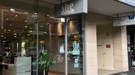 She hairdressing entrance showcasing modern decor and services in Melbourne, Victoria, AU.