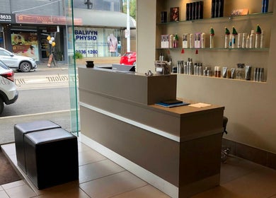 Reception area of She hairdressing in Melbourne, Victoria, AU with modern decor and hair products displayed.