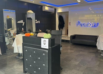 Interior of Frankies Barbers & Tanning in Biggleswade, England, GB, featuring stylish chairs and sleek decor.