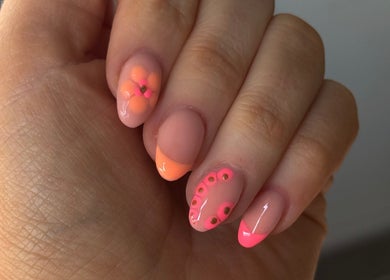 Elegant nail art design featuring pink and orange florals at Byellaofm in Birmingham, England, GB.
