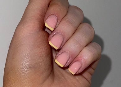 Yellow-tipped French manicure at Byellaofm, Birmingham, England, GB showcasing elegant nail design.