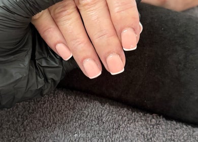 Fresh French manicure at Byellaofm, Birmingham, England, GB showcasing elegant nail styling.