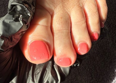 Close-up of coral pedicure at Byellaofm in Birmingham, England, GB, highlighting detailed nail care.