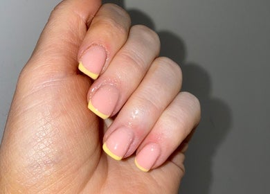 Elegant yellow-tipped manicure at Byellaofm, Birmingham, England, GB showcasing vibrant style.