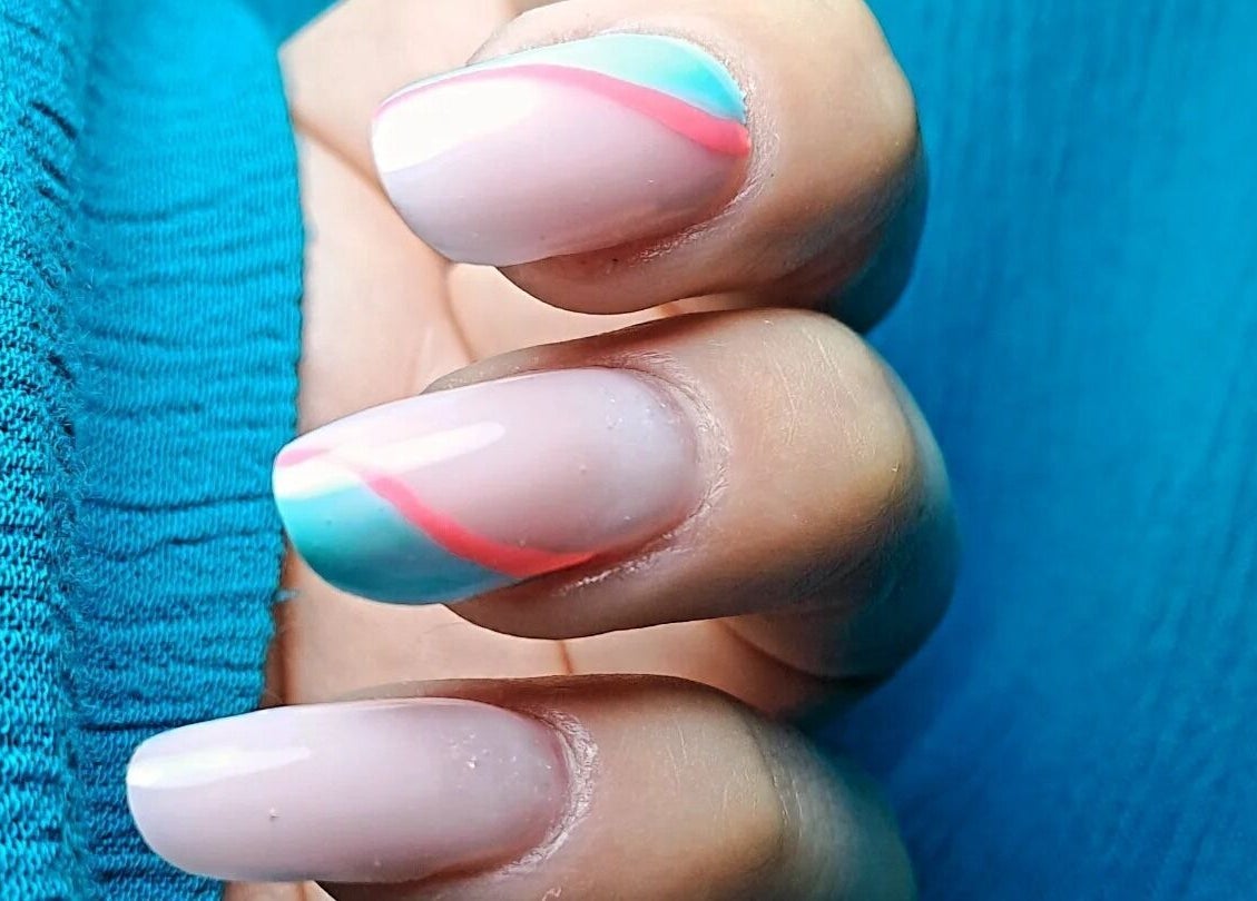 Close-up of vibrant nail art at MS Hair&Beauty, Naxxar, MT, showcasing colorful designs on nails.