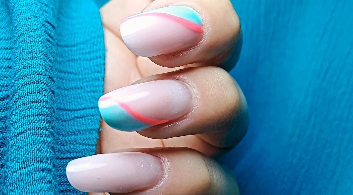 Close-up of vibrant nail art at MS Hair&Beauty, Naxxar, MT, showcasing colorful designs on nails.