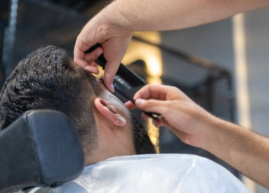 Close-up of barber styling hair at Ace Lebanese Barber Shop in Al Khobar, Eastern Province, SA.
