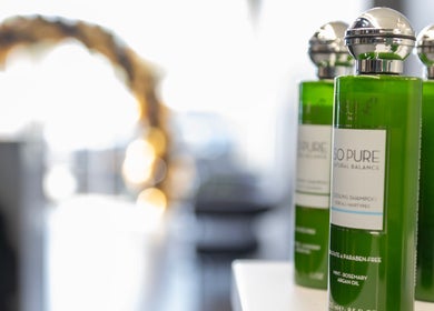 Organic shampoo bottles at Ace Lebanese Barber Shop in Al Khobar, Eastern Province, SA, showcasing natural products.